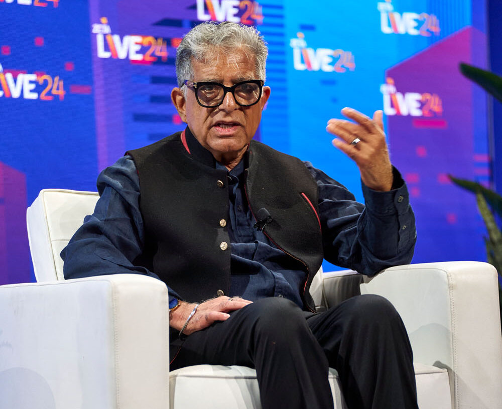 Deepak Chopra, wellness expert and author, speaking at Zeta Live 2024, discussing the synergy between mindfulness, well-being, and business innovation.